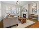 Cozy living space with a fireplace, plantation shutters, and stylish furniture at 2880 Emporia Ct, Denver, CO 80238