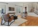 Inviting living room with gleaming wood floors and an open layout to the dining area at 2880 Emporia Ct, Denver, CO 80238