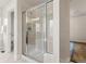 Modern glass shower with neutral tile and updated fixtures for a spa-like experience at 2880 Emporia Ct, Denver, CO 80238
