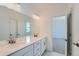Elegant bathroom with double sinks, quartz countertops, and modern fixtures for a spa-like experience at 2916 Oxley St, Strasburg, CO 80136