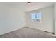 Cozy bedroom featuring soft carpeting, natural light, and a tranquil atmosphere at 2916 Oxley St, Strasburg, CO 80136