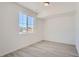 Bright, modern bedroom with large window and neutral-colored walls and flooring at 2916 Oxley St, Strasburg, CO 80136