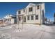 Two-story white house with gray accents, snowy yard, and other houses in the background at 2916 Oxley St, Strasburg, CO 80136