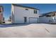 Two-story home with a two car garage, set against a snowy backdrop at 2916 Oxley St, Strasburg, CO 80136