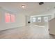 Bright living room featuring a modern fireplace and light wood-look floors at 2916 Oxley St, Strasburg, CO 80136