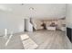 Spacious open concept living room with lots of natural light and view into the kitchen at 2916 Oxley St, Strasburg, CO 80136