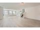 Bright, spacious living area with large windows and an adjacent staircase at 2916 Oxley St, Strasburg, CO 80136