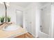 Tiled bathroom featuring a shower-tub, vanity with sink, large mirror, and decorative green plants at 3815 Red Deer Trl, Broomfield, CO 80020
