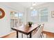 Cozy dining area with a wood table, upholstered chairs, and lots of natural light from windows at 3815 Red Deer Trl, Broomfield, CO 80020