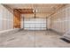 Empty garage features white walls, concrete floors, and a garage door at 3815 Red Deer Trl, Broomfield, CO 80020