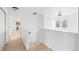 Well-lit upper hallway features neutral carpet, a staircase, and entry to a bedroom at 3815 Red Deer Trl, Broomfield, CO 80020