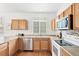 Kitchen featuring wood cabinetry, stainless appliances, and updated countertops at 3815 Red Deer Trl, Broomfield, CO 80020