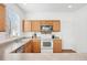 Bright kitchen features stainless steel appliances, wooden cabinets, a breakfast bar and sleek countertops at 3815 Red Deer Trl, Broomfield, CO 80020