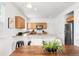 Kitchen view featuring updated appliances, wood cabinets, counter seating, and open layout at 3815 Red Deer Trl, Broomfield, CO 80020