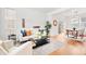 Open-concept living room flows to dining area with hardwood floors and contemporary design at 3815 Red Deer Trl, Broomfield, CO 80020