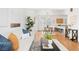 Bright, open-concept living space with hardwood floors leading to the dining area and kitchen at 3815 Red Deer Trl, Broomfield, CO 80020