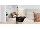 Comfortable sitting area in main bedroom with neutral decor, comfortable chair, and decorative blanket at 3815 Red Deer Trl, Broomfield, CO 80020