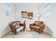 Inviting sitting area with two armchairs, neutral decor, window views, and art on the walls at 3815 Red Deer Trl, Broomfield, CO 80020