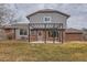 View of home's brick and siding exterior with a cozy pergola-covered patio at 3673 E Nichols Ave, Centennial, CO 80122