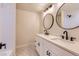 Elegant bathroom features a double vanity with sleek fixtures and modern design at 3673 E Nichols Ave, Centennial, CO 80122