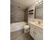 Charming bathroom featuring a tiled shower-tub, storage, and stylish accents at 888 N Logan St # 2C, Denver, CO 80203