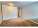 Bright bedroom featuring a large closet, carpet floors, and access to the bathroom at 888 N Logan St # 2C, Denver, CO 80203