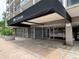 Condominium building entrance featuring a covered entrance with glass doors and planters outside at 888 N Logan St # 2C, Denver, CO 80203