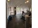 Bright gym featuring modern equipment, rubber flooring, and natural light streaming through sheer curtain-lined windows at 888 N Logan St # 2C, Denver, CO 80203