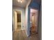 Neutral hallway leading to the tiled bathroom and carpeted rooms with modern lighting at 888 N Logan St # 2C, Denver, CO 80203