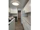 Functional kitchen featuring white cabinets and stainless steel dishwasher at 888 N Logan St # 2C, Denver, CO 80203
