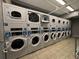 A commercial laundry room featuring multiple rows of coin operated washing machines at 888 N Logan St # 2C, Denver, CO 80203