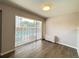 Living room with sliding glass doors and laminate flooring at 888 N Logan St # 2C, Denver, CO 80203