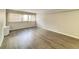 The living room is bright with natural light and wood-look flooring at 888 N Logan St # 2C, Denver, CO 80203