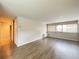 Open living room with wood-look flooring, neutral walls, and ample natural light, perfect for relaxing or entertaining at 888 N Logan St # 2C, Denver, CO 80203