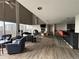 Bright living room with vaulted ceilings, a fireplace, bar seating, and expansive windows offering city views at 888 N Logan St # 2C, Denver, CO 80203