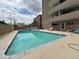 Outdoor pool surrounded by lounging areas, with buildings in the background at 888 N Logan St # 2C, Denver, CO 80203