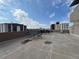 Outdoor rooftop terrace with multiple tables and chairs, with city views at 888 N Logan St # 2C, Denver, CO 80203