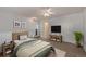 Cozy bedroom includes a ceiling fan, decorative art, and a comfortable bed at 17053 E Tennessee Dr # 212, Aurora, CO 80017