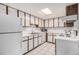 Functional kitchen featuring ample cabinet space, white appliances, and a well-lit tile floor at 17053 E Tennessee Dr # 212, Aurora, CO 80017