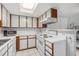 Bright kitchen with classic white cabinetry, modern appliances, and a convenient layout for cooking at 17053 E Tennessee Dr # 212, Aurora, CO 80017