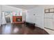Bright living room with a cozy fireplace, sleek hardwood floors, and a view from the window at 17053 E Tennessee Dr # 212, Aurora, CO 80017