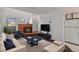 Bright living room features a fireplace, stylish furnishings, and modern entertainment center at 17053 E Tennessee Dr # 212, Aurora, CO 80017