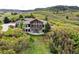 Elevated angle of an attractive dwelling set amongst flourishing greenery and a private drive at 580 Summer Mist Cir, Castle Rock, CO 80104
