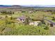 Aerial view of stunning estate on sprawling acreage with mature landscaping, mountain views, and circular drive at 580 Summer Mist Cir, Castle Rock, CO 80104