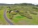 Aerial view of an estate situated on lush land, with a long driveway leading to the beautiful house at 580 Summer Mist Cir, Castle Rock, CO 80104