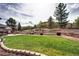Well maintained backyard with terraced landscaping and patio at 580 Summer Mist Cir, Castle Rock, CO 80104