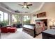 Spacious bedroom with sitting area, tray ceilings, bay window and ceiling fan at 580 Summer Mist Cir, Castle Rock, CO 80104