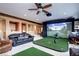 Entertainment room with golf simulator, comfortable seating, and a ceiling fan at 580 Summer Mist Cir, Castle Rock, CO 80104