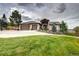 Elegant home with a three-car garage, manicured lawn, and basketball court on a sunny day at 580 Summer Mist Cir, Castle Rock, CO 80104
