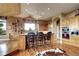 Bright kitchen features natural wood cabinets, a large window, and bar seating at 580 Summer Mist Cir, Castle Rock, CO 80104